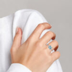 white gold aquamarine and diamond ring on finger