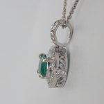side view of emerald and diamond pendant