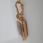 side view of yellow gold pendant