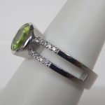 side view of white gold peridot and diamond ring