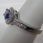 side view of tanzanite and diamond halo ring