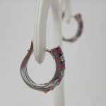 side view of ruby and diamond hoop earrings