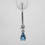 close up view of blue zircon and diamond dangle earring