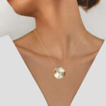 yellow gold circular diamond disc necklace on model