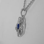 side view of white gold diamond and sapphire and pendant