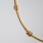 close up view of yellow gold necklace