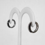 side view of white gold black and colorless diamond hoops