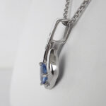 side view of white gold sapphire and diamond pendant