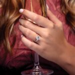 three stone diamond engagement ring on finger