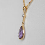 side view of amethyst and diamond pendant