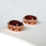 side view of rose gold oval garnet and diamond studs