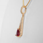 side view of yellow gold ruby and diamond pendant