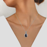 white gold oval sapphire and diamond pendant on model