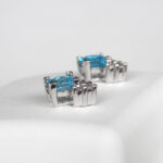 side view of white gold blue topaz and diamond earrings