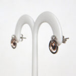 side view of sterling silver and rose gold earrings