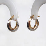 side view of two tone gold hoop earrings