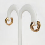 side view of yellow gold hinged hoop earrings