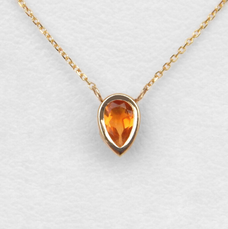 close up view of yellow gold pear shape citrine necklace