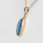side view of yellow gold opal and diamond pendant