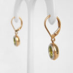 side view of peridot dangle earrings