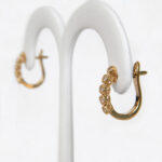 side view of yellow gold diamond hoop earrings