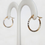 side view of two tone gold hoop earrings