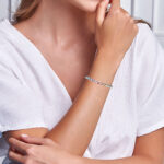sterling silver multi colored sapphire bangle on wrist