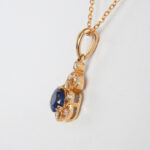 side view of yellow gold sapphire and diamond pendant