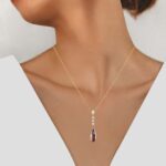 yellow gold garnet and diamond pendant on model