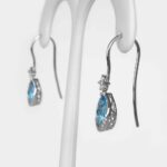 side view of blue topaz dangle earrings