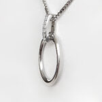 side view of open oval silver pendant