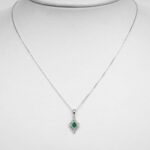white gold emerald and diamond pendant on chain