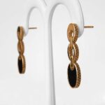 side view of yellow gold black onyx dangle earrings
