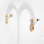 side view of yellow gold opal and diamond earrings