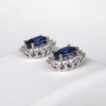 side view of white gold oval sapphire and diamond earrings