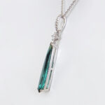 side view of white gold green tourmaline and diamond pendant