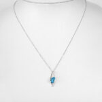 white gold blue topaz and diamond pendant on chain