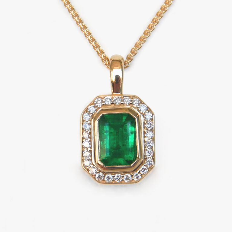 yellow gold emerald and diamond halo pendant