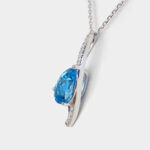 side view of white gold blue topaz and diamond pendant