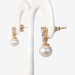 side view of pearl and diamond dangle earrings