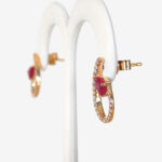 side view of yellow gold ruby and diamond earrings