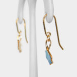 side view of yellow gold blue ginkgo dangle earrings