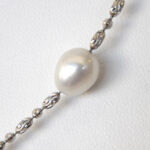 close up view of sterling silver freshwater pearl station necklace