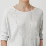 long pearl station necklace on model