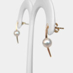 side view of yellow gold pearl earrings