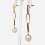 side view of yellow gold paperclip dangle earrings