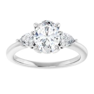 white gold three stone ring with oval diamond in the center and pear shaped diamonds on the side