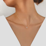 rose gold three stone diamond necklace on model