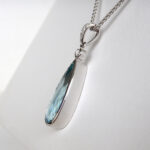 side view of aquamarine and diamond pendant