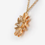 side view of yellow gold diamond sun necklace